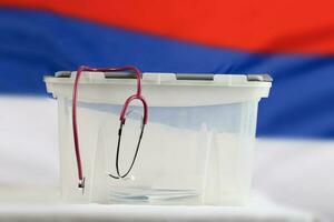 Stethoscope is hanging on the ballot box. Closeup photo