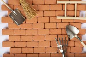 Agricultural tools on a brick wall. Background. Closeup photo