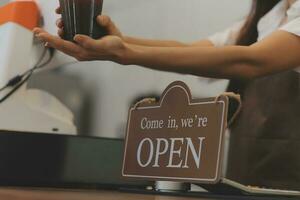 Portrait of a woman, a coffee shop business owner who is smiling beautifully and opening a coffee shop that is her own business, SME concept. photo