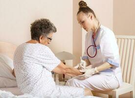 Geriatrician visits a senior woman photo