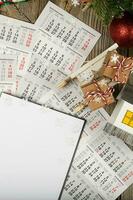 Blank sheet of paper and small paper house with coins on the New Year's background. photo