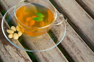 Traditional tunisian green tea with peppermint and nuts photo