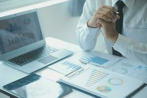 Close up businessman hand using calculator and working with laptop calculate about finance accounting at coffeeshop outdor.finance accounting concept photo