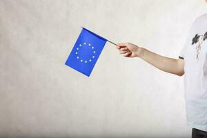 A hand with a flag of the  EU. Free space for a text photo