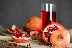 Glass of pomegranate juice on a wooden surface. photo