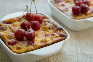 Homemade cherry mini pies in the ceramic baking moulds photo