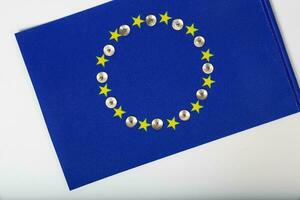 Metallic pins on an European flag.Background. Closeup photo