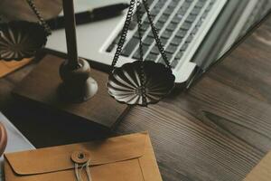 Business and lawyers discussing contract papers with brass scale on desk in office. Law, legal services, advice, justice and law concept picture with film grain effect photo