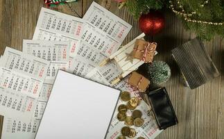 Blank sheet of paper and small purse with coins on the New Year's background. photo