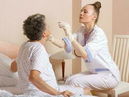 Geriatrician visits a senior woman photo