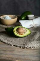 Avocado section on a wooden surface. photo