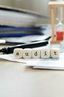 Word AUDIT composed of wooden letters. Closeup photo