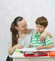 The mother checks the homework of her son photo