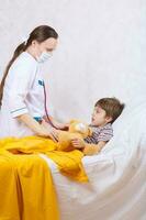 A child and a paediatrician in her cabinet photo