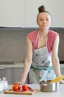 Young housewife in the kitchen photo