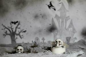 Skull on an old used thick candle. Scary Halloween background. photo