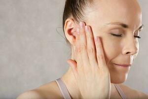 Ear of a young caucasian lady. Closeup photo