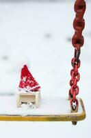 Santa Claus hat on a wooden made sleigh. Closeup photo