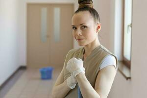 Young cleaning lady is cleaning the corridor. photo