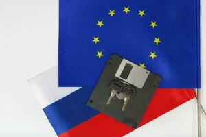 Floppy disk,keys,two flags on a white surface photo