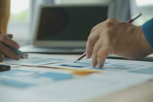 Close up ux developer and ui designer brainstorming about mobile app interface wireframe design on table with customer breif and color code at modern office.Creative digital development agency photo