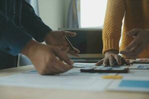 Close up ux developer and ui designer brainstorming about mobile app interface wireframe design on table with customer breif and color code at modern office.Creative digital development agency photo