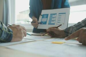 Close up ux developer and ui designer brainstorming about mobile app interface wireframe design on table with customer breif and color code at modern office.Creative digital development agency photo