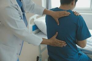 Professional orthopedist examining little patient's leg in clinic photo