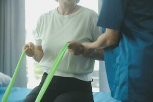 Physiotherapist working with patient in clinic, closeup photo