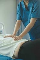 A Modern rehabilitation physiotherapy worker with senior client photo