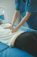 A Modern rehabilitation physiotherapy worker with senior client photo