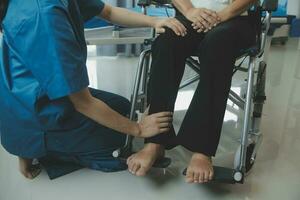 happy senior asian woman talking to physical therapist in rehab center photo