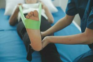 Physiotherapist working with patient in clinic, closeup photo