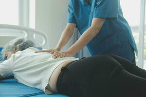A Modern rehabilitation physiotherapy worker with senior client photo