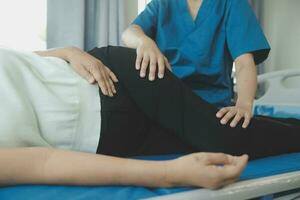 Physiotherapist working with patient in clinic, closeup photo