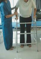 happy senior asian woman talking to physical therapist in rehab center photo