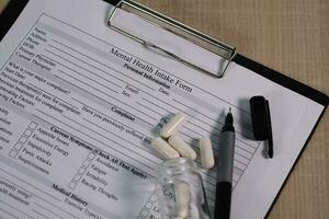 Mental health intake form and a pen on a table. photo