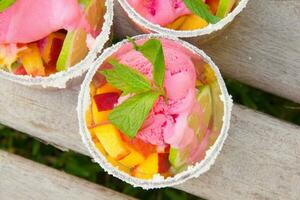 Fruit salad with strawberry ice cream photo