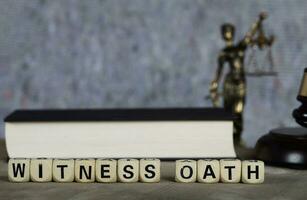 Word WITNESS OATH composed of wooden letters. photo