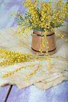 Mimosa flowers on a wooden surface. Closeup photo