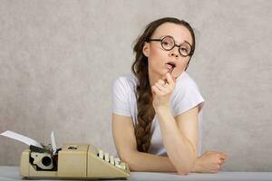 Young lady  with typing machine. Closeup photo