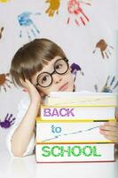 Boy of seven years old with books. Back to school photo