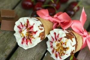 Cherry vanilla ice-cream with caramel topping. Closeup photo