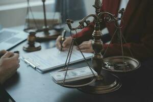 Justice and law concept.Male judge in a courtroom with the gavel, working with, computer and docking keyboard, eyeglasses, on table in morning light photo