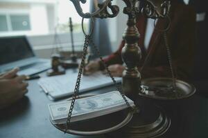 Justice and law concept.Male judge in a courtroom with the gavel, working with, computer and docking keyboard, eyeglasses, on table in morning light photo