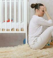 A young depressed mother in a postpartum period photo