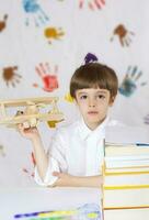 Boy of seven years old with books. Back to school photo