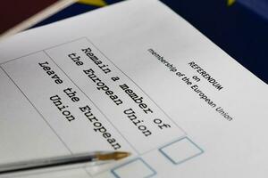 EU Referendum ballot paper, black pen, and passport on the table. photo