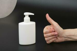 Liquid soap dispenser and a human hand photo