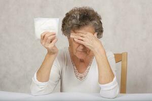 Old woman and panty liner for incontinence photo